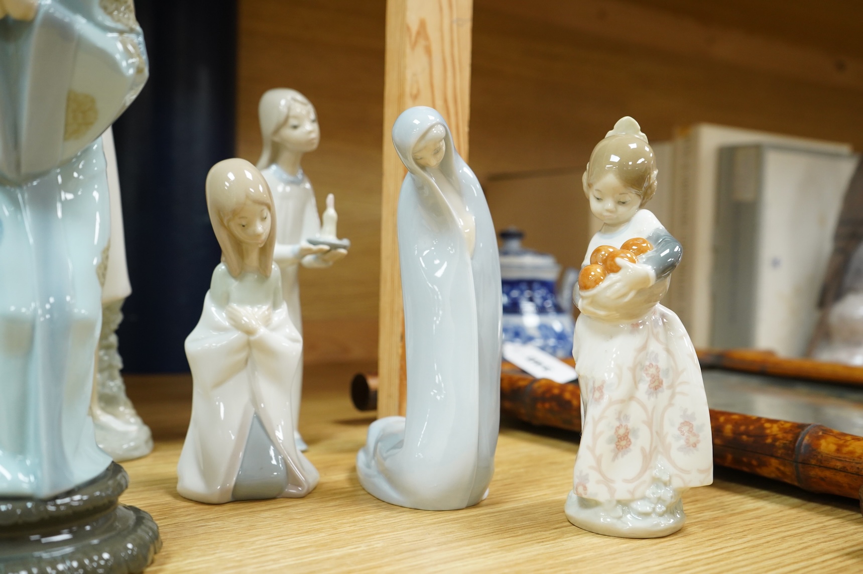 A group of Lladro figures - two Nuns, Geisha, Priest, Virgin Mary, Orange Girl with candle, Girl praying (8) tallest Nuns 33cm high